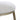 Close-up of a stool with a white cushioned seat and gold metal legs on a white background