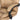 Beige quilted leather chair with black armrest on a white background