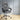 Gray office chair with quilted design on a wooden floor and light gray wall background