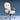 Beige office chair with black armrests on a blue background