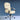 Beige office chair with black armrests on a blue background