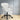 White office chair with black wheels on a wooden floor.