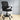 Black office chair with mesh backrest in a room with light-colored floor and white walls.