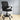Black office chair with mesh backrest in a room with light-colored floor and white walls.