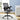 Gray office chair with mesh back in a room with a desk and plant.