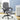 Gray executive office chair in a room with a desk and plants.