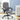 Gray executive office chair in a room with a desk and plants.