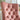 Pink tufted chair with gold nailhead trim in a room setting