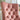 Pink tufted chair with gold nailhead trim in a room setting