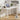 White desk with laptop, lamp, and plant in a room setting