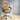 Beige office chair with quilted design on a wooden floor and light gray wall background