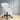 White office chair with black wheels on a wooden floor.